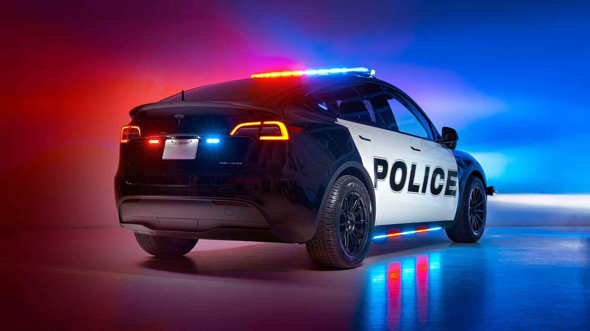 Unplugged performance upfit tesla model y police vehicle exterior rear three quarter view